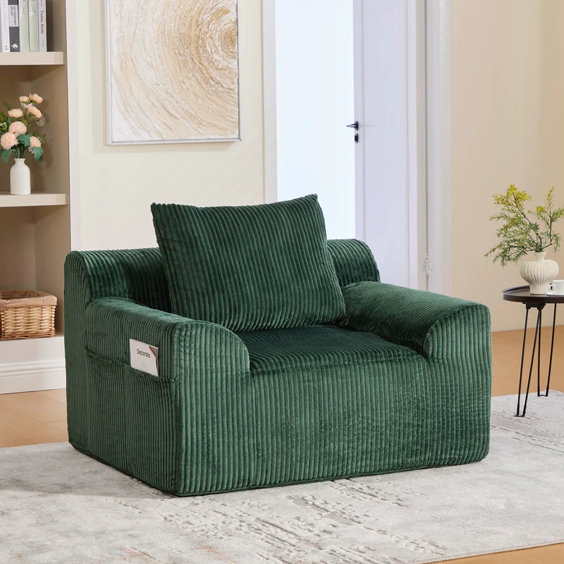 Canapé simple fauteuil XXL en velours côtelé vert, dossier profond, repose pied, coussin & poches latérales, sans montage MILKWEEDFLOSS