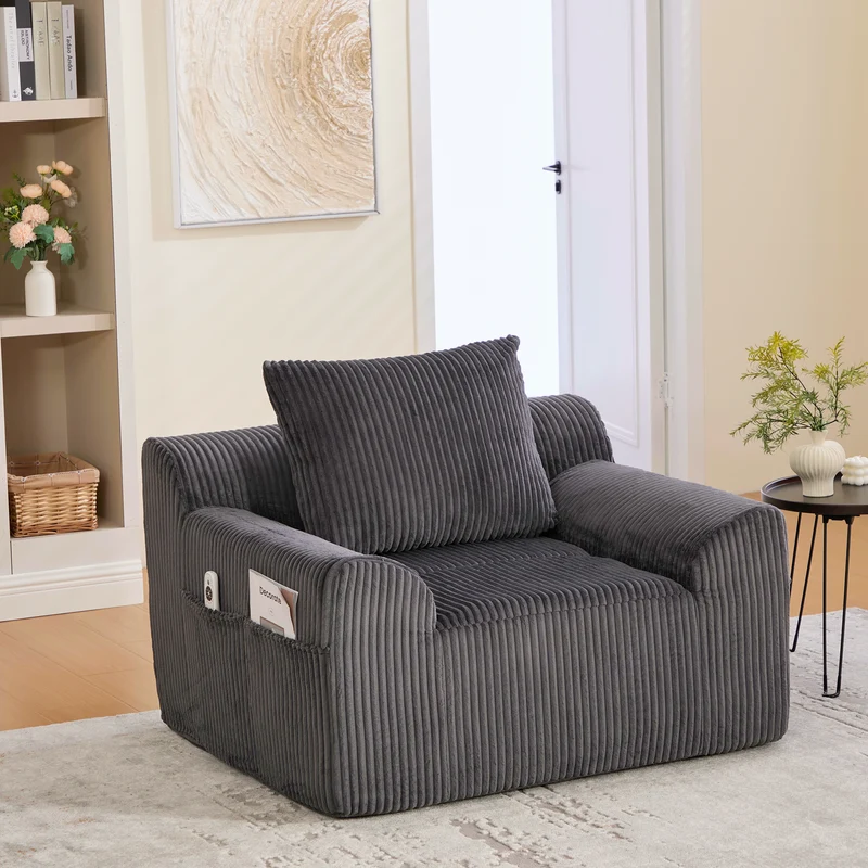 Canapé simple fauteuil XXL en velours côtelé gris, dossier profond, repose pied, coussin & poches latérales, sans montage HOTSPRINGPOOL